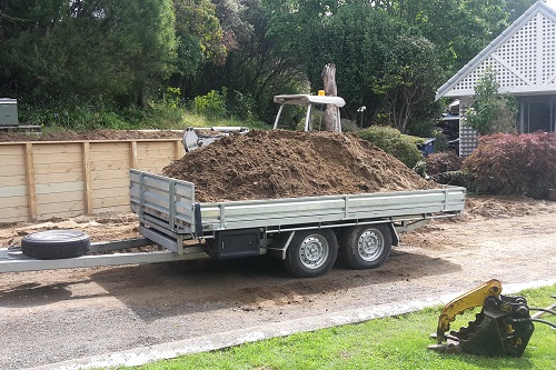 2T Digging's tipping trailer load with earth. 2T Digging's tipping trailer load with earth.